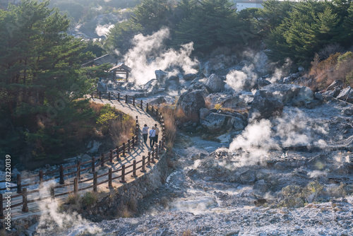 people walk Hell valley Jigoku path at Mt. Unzen onsen, Nagasaki