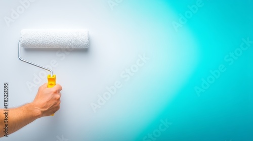 Painting wall person holds paint roller for home decor wall painting in progress roller prepares surface for color