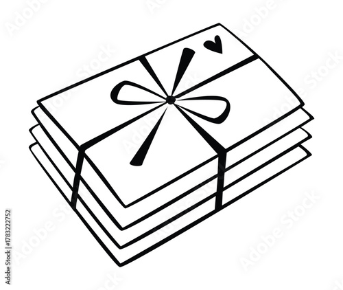 A stack of envelopes tied with a ribbon and bow and a small heart in the upper right corner