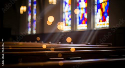 Sunlight Streaming Through Stained Glass Windows in Empty Church , Tranquil Church Interior with Sunlight and Rows of Empty Wooden Pews