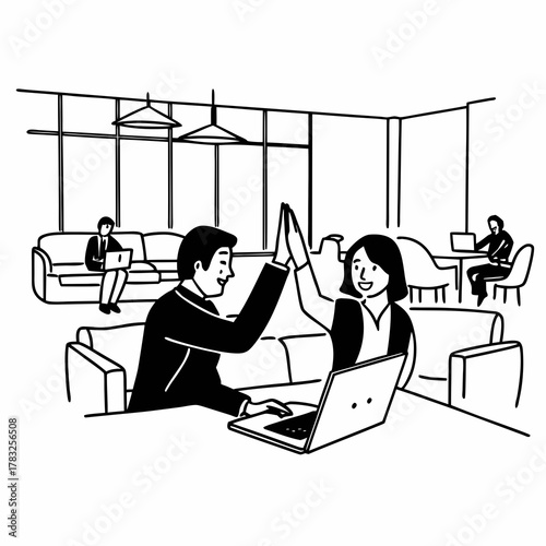 Successful business people giving each other a high five while working on laptop in coworking