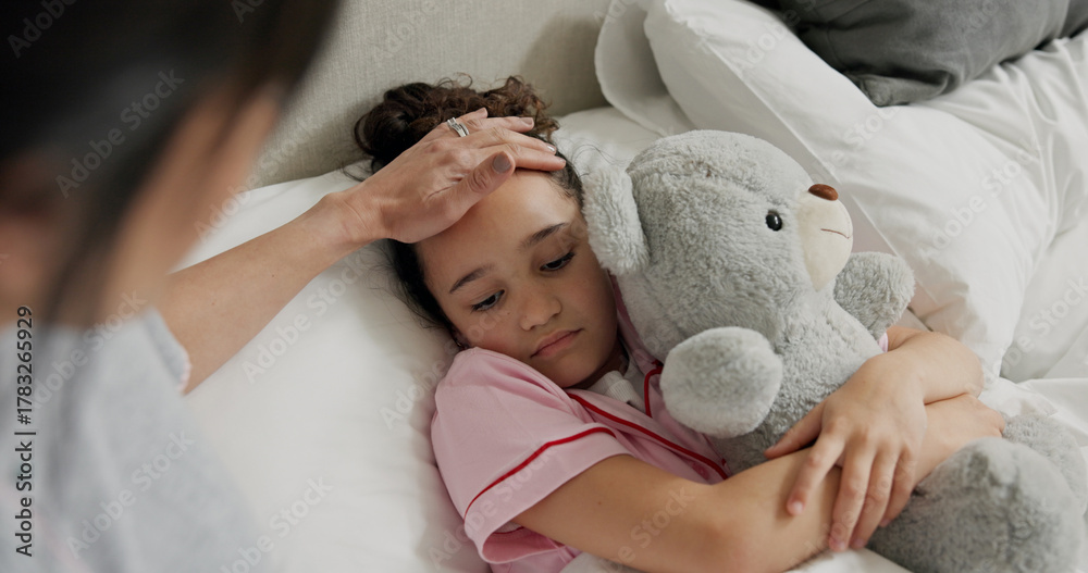 Naklejka premium Mother, sick child and check for fever in bed, support and monitor illness symptoms of daughter. Comfort, teddy bear and woman care for sad girl with temperature, virus infection and touch forehead