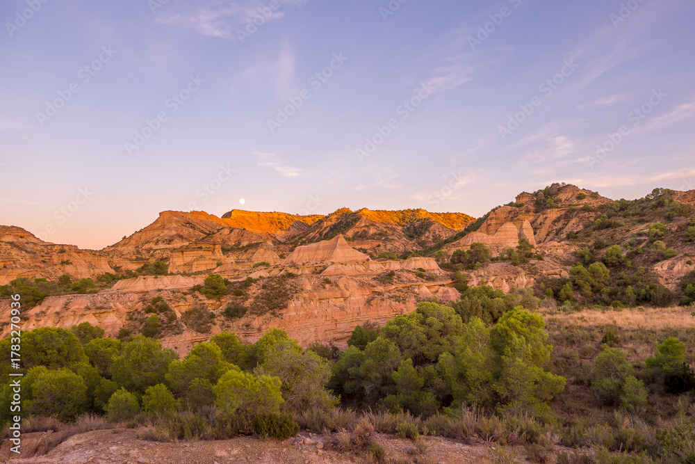 Obraz premium Lunar landscapes of the Monegros desert at sunrise and sunset, Spain