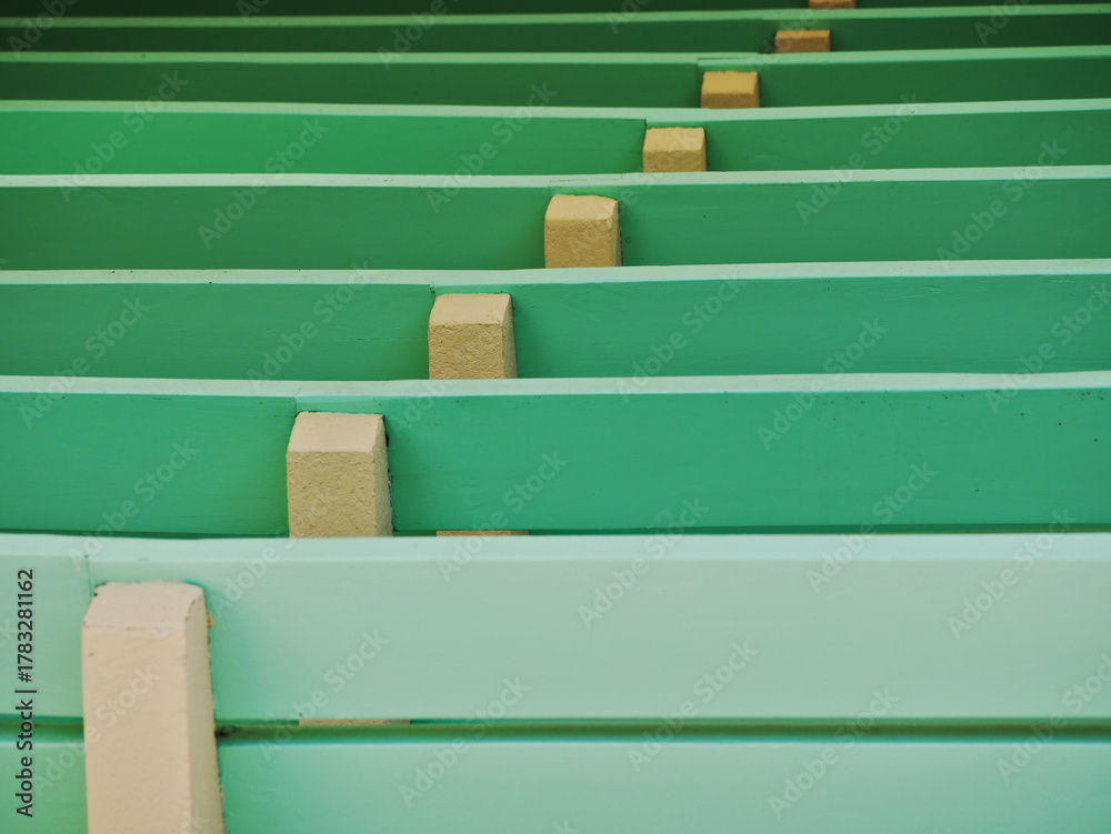 Obraz premium rows of wooden seats in an open air theater painted in colorful green