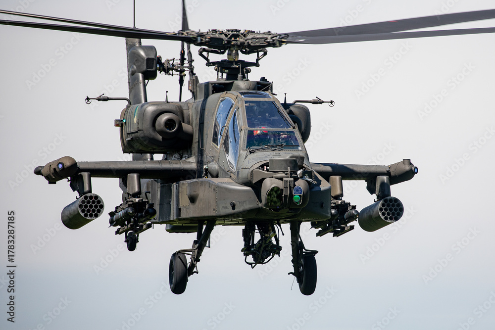 Fototapeta premium Military Apache Helicopter Flying at Low Altitude