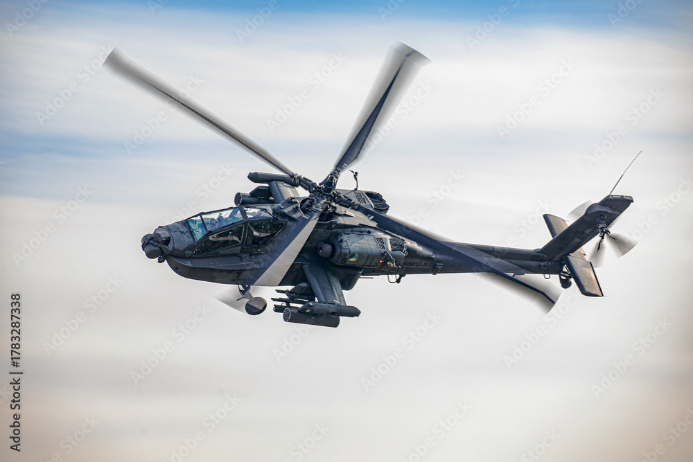 Fototapeta premium Military Apache Helicopter Flying at Low Altitude