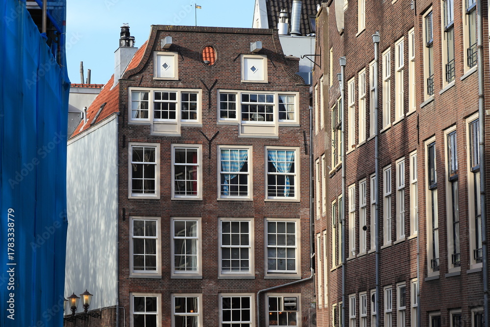 Fototapeta premium Oudezijds Voorburgwal Brick House Facades in Amsterdam, Netherlands