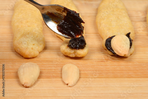 Vászonkép A close-up horizontal shot showing a spoonful of dark plum jam being applied to