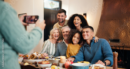 Obraz na plátně Christmas, food and photograph with family at dining room together for celebration or memories