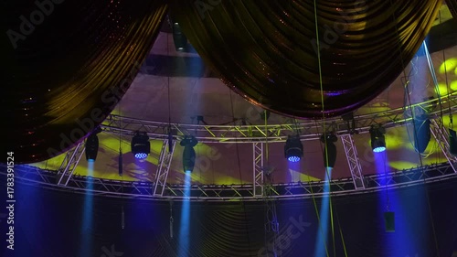 Dynamic ceiling stage lights projected onto a circus dome with drapes. The colorful movement and beams create a dramatic, festive atmosphere perfect for live shows and entertainment