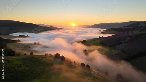Stunning Sunrise Over Misty Valley with Rolling Hills and Golden Light.