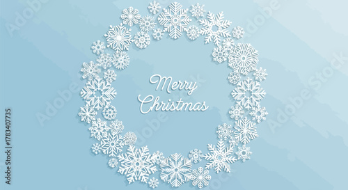 Delicate white snowflakes forming a circular wreath with a soft blue background and subtle sparkle effects