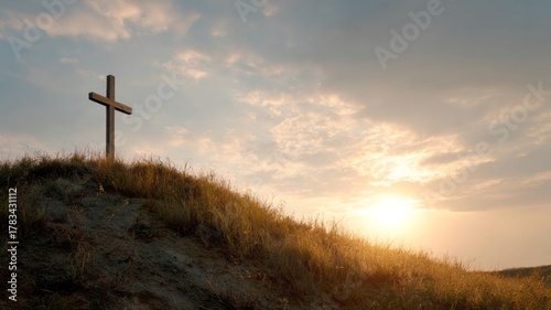 Sunrise illuminates a lone wooden cross atop a hill, evoking Easter dawn vigils and spiritual renewal in serene solitude