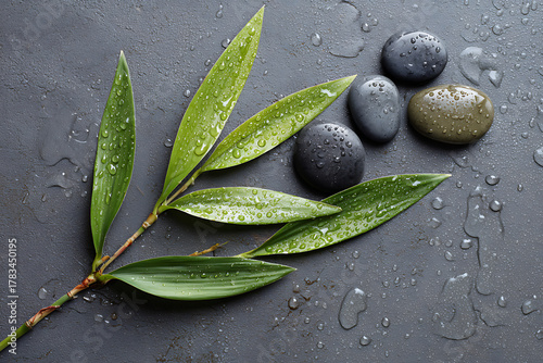 Zen stones and bamboo leaves with water droplets evoke peace, tranquility, and spa lifestyle, perfect for wellness retreats and meditation.
