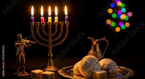 Menorah with lit candles and sufganiyot for hanukkah celebration