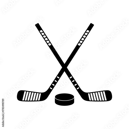 Crossed ice hockey sticks and puck. winter sport equipment symbol.