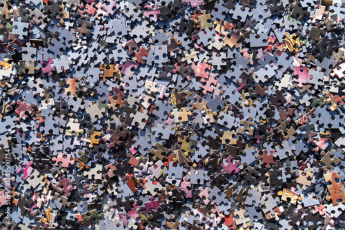A photo of the background from a colored puzzle.There are a lot of puzzle pieces on the table.Logical tasks for the mind.