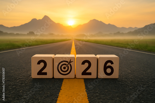 Target goal and new year resolution concept for the year 2026 symbolized by wooden blocks with numbers and a crosshair icon on a long asphalt road
