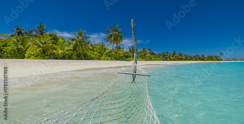 Fototapeta Naklejka Na Ścianę i Meble -  First person view hammock background clear turquoise ocean water white sandy beach lush green palm trees sunny blue sky. Relaxing tropical paradise relaxation summer holiday travel escape destination