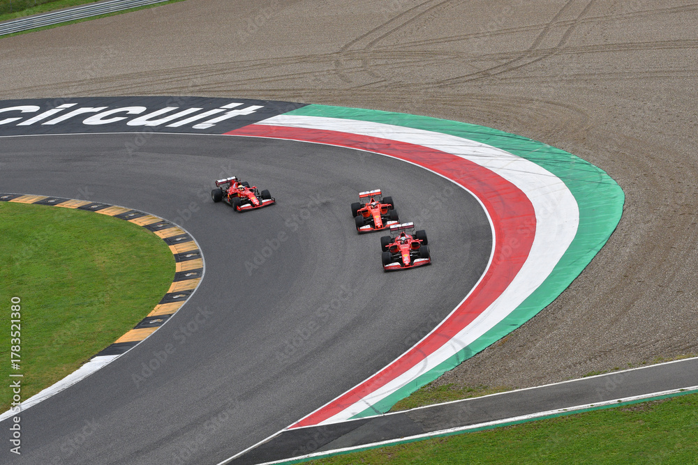 Obraz premium Scarperia; Italy - October 24th 2025: Ferrari SF90 and SF1000 ex Sebastian Vettel and Charles Leclerc in action during Ferrari World Finals 2025 at Mugello Circuit in Italy.