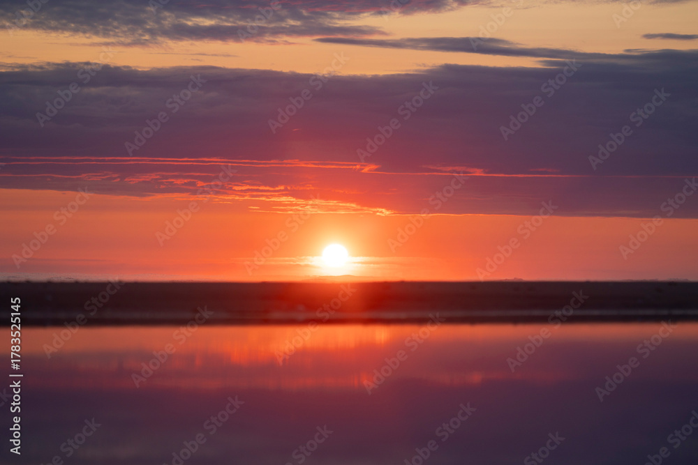 Fototapeta premium A baeuriful pink sunrise over the Baltic Sea. Summer morning at the beach. Latvia, Europe.
