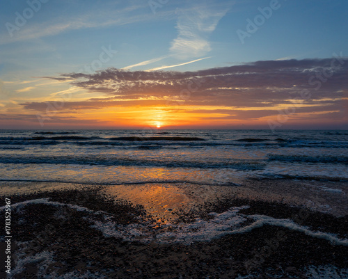 Fototapeta Naklejka Na Ścianę i Meble -  A beautiful, colorful summer sunset over the Baltic Sea. Summer evening at the beach in Latvia, Europe.