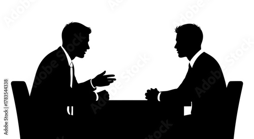 Two men in suits silhouette facing each other across a table