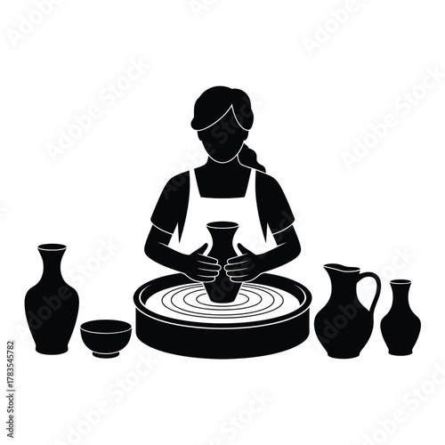 Silhouette of a potter shaping clay on a spinning wheel