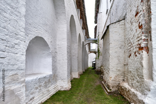 A narrow passage between two fortress walls of the white-stone Rostov Kremlin. The ancient walls of the Kremlin