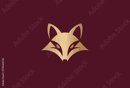 A sleek and modern logo representing a fox in gold on a rich burgundy background, symbolizing wisdom and cleverness in design and branding.