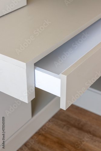 white desk of a office with open drawer