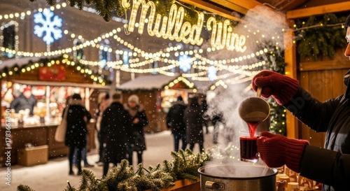 Gloved hands pouring hot mulled wine at Christmas market