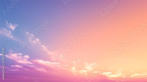 Fototapeta Naklejka Na Ścianę i Meble -  A gradient sky with soft clouds transitioning from purple to orange hues above horizon
