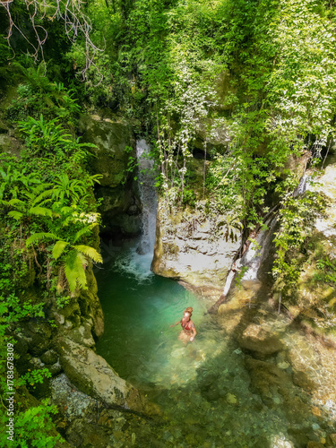Woman Swimming in Fairy Pool beneath Candalla Waterfall, Camaiore, Tuscany, Italy