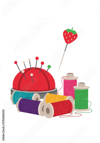 Collection of sewing supplies including a pin cushion, spools of colorful thread, and a strawberry-shaped pin.