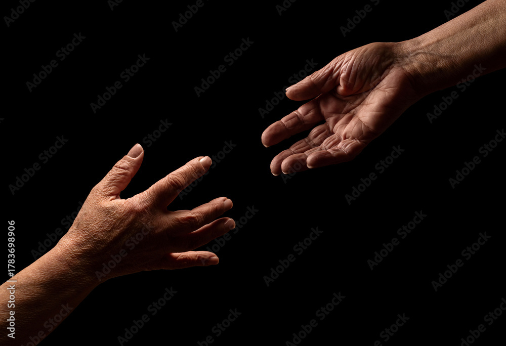 Fototapeta premium Help hands holding together representing friendship, partnership, help and hope, donation. Helping old. Hand is helping older hand