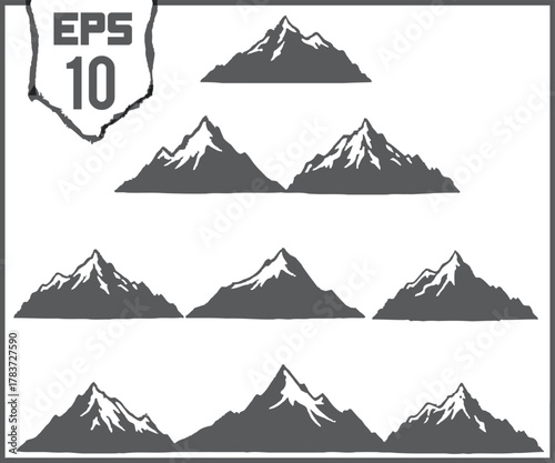 Collection of stylized mountain range silhouettes with snow capped peaks and rugged textures for design