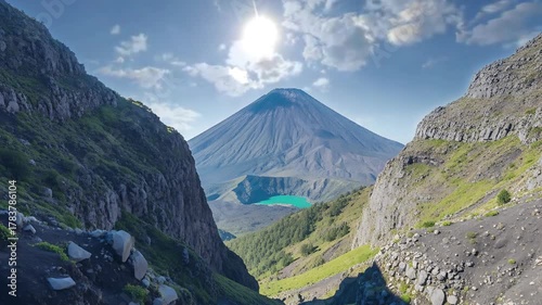 Stunning Mountain Valley with Volcanic Peak, Blue Crater Lake, and Bright Sunlight in Scenic Landscape seemless looping quality video 4K 