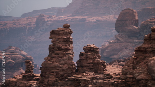 Valokuva Towering stone structures stand proud in a remote desert canyon, bathed in warm hues