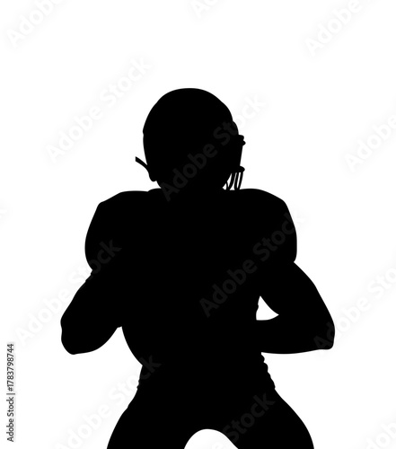 Silhouette of an american football player in uniform ready to throw a pass against a stark white background