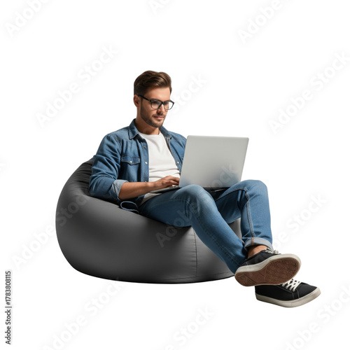 Full body young smiling happy man sitting in bag chair, holding and using on laptop isolated on white background