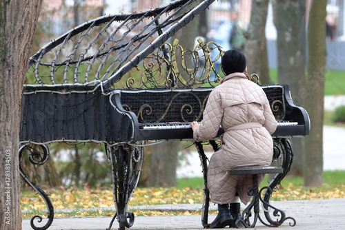 Photos A woman at a makeshift piano in a city park