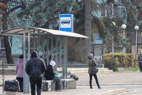 People waiting for transport at a bus stop