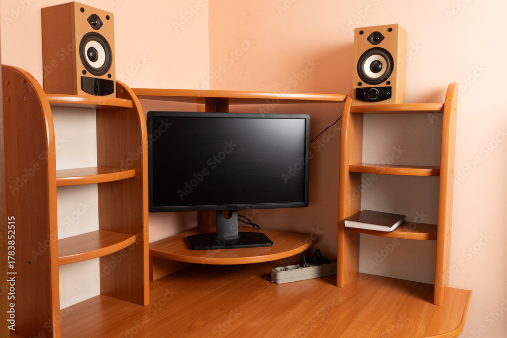 Fototapeta premium Workspace with monitor, speakers, extension cord and notepad