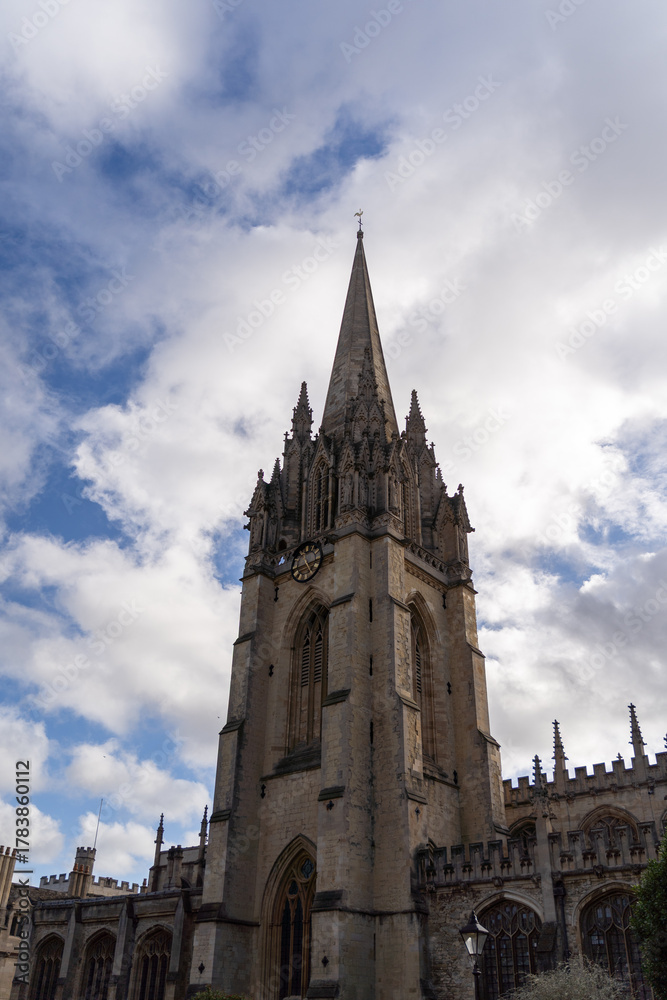 Fototapeta premium Majestic cathedral tower under cloudy sky