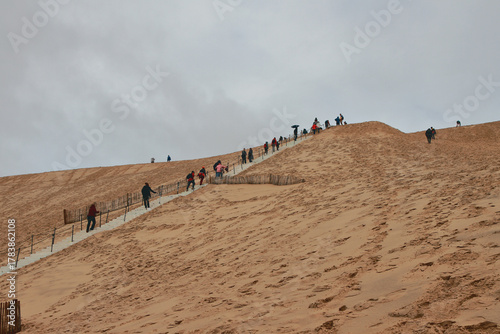 Tourists climb Dune Peel. Arcachon, Bordeaux, France