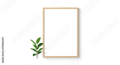 Elegant vertical wooden frame mockup with a crisp white blank canvas, beautifully accented by a fresh green leafy sprig, ideal for minimalist presentations and natural decor