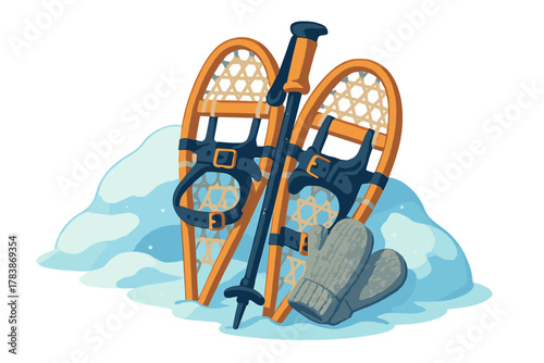 Classic wooden snowshoes, hiking pole, and knitted mittens resting in a mound of fresh winter snow