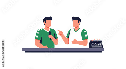 Two men in green and white shirts are standing behind a desk with a microphone and a scoreboard.