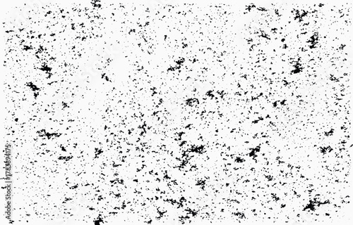 Textured grunge vector pattern with scattered black elements on a white background suitable for design projects and creative applications